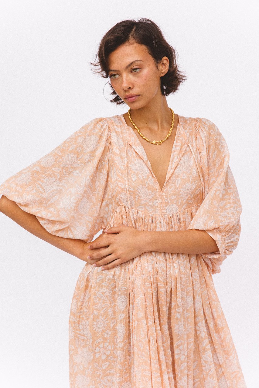 Daughters of India Kyra Midi Dress in Apricot Blush — studio close-up V-neckline and gathered waist, floral hand screen print