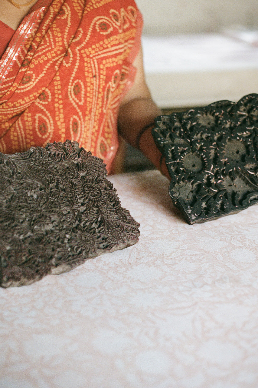Daughters of India — Jaipur artisan hand block printing floral pattern with carved wooden blocks onto cotton fabric